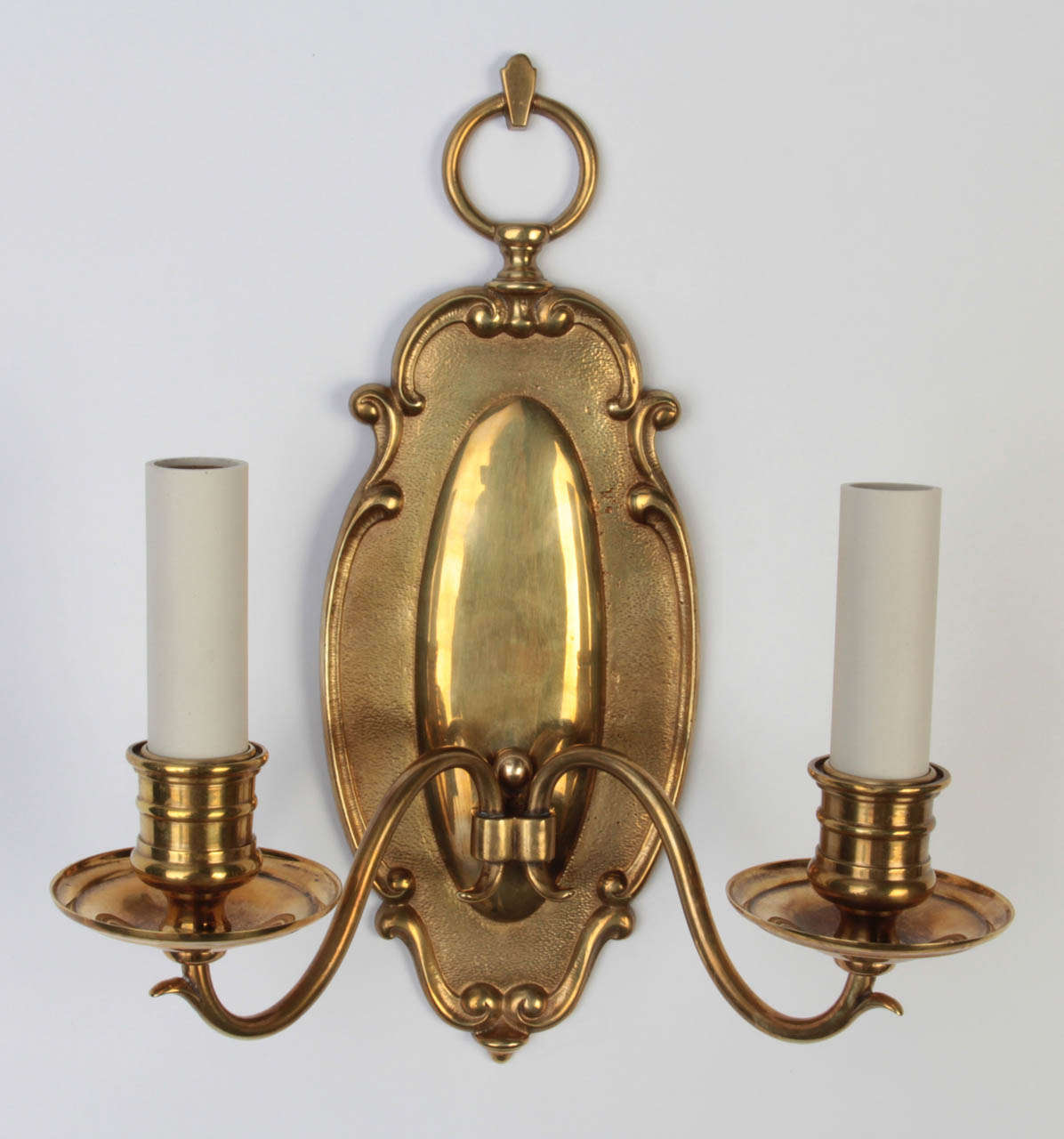 A pair of double light cast brass sconces in a mellow hand polished patina.

Dimensions:
Overall: 12-1/2