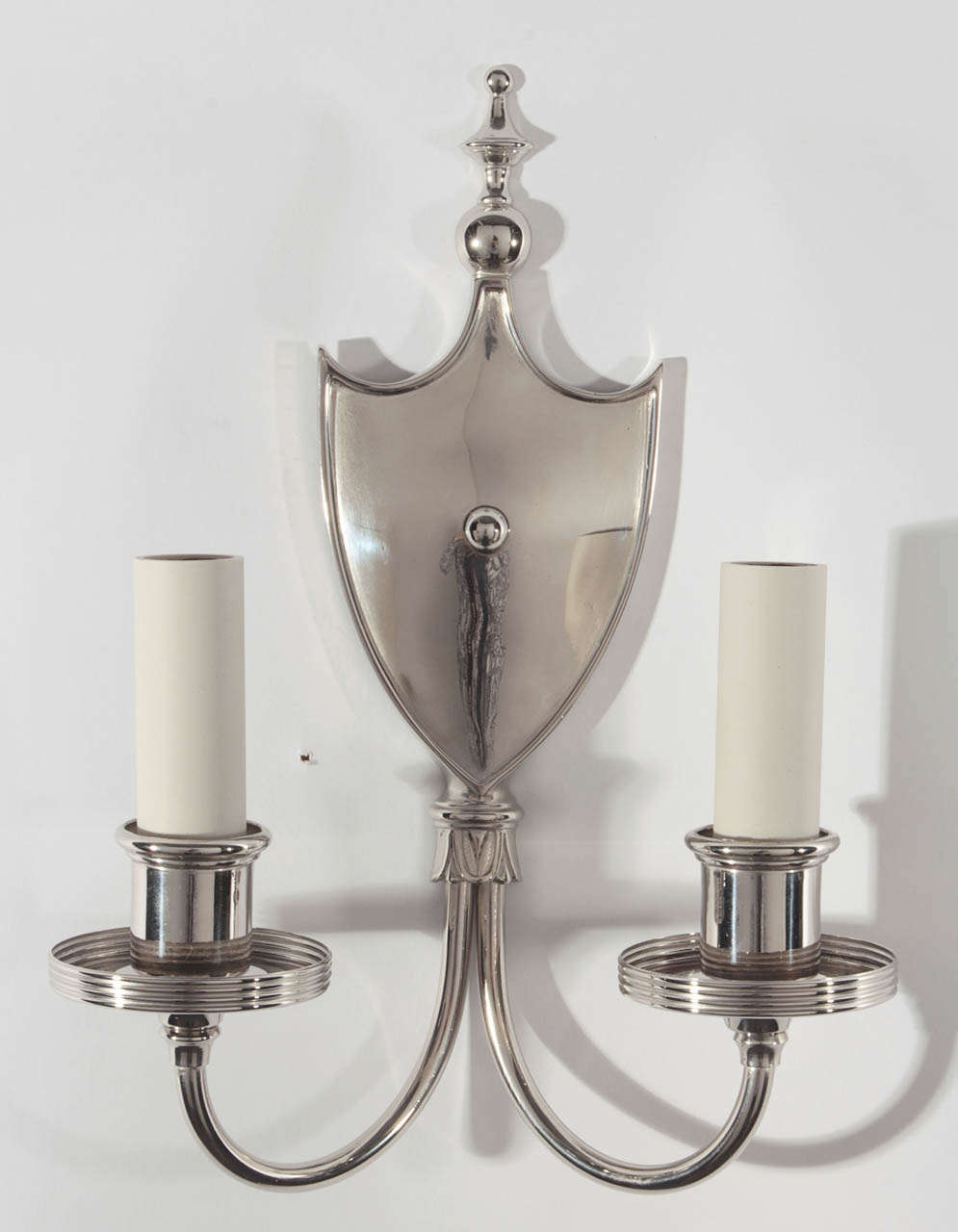 A pair of solid brass double-light sconces in with shield-form backplates in a nickel finish.

DIMENSIONS
Overall: 11-3/8