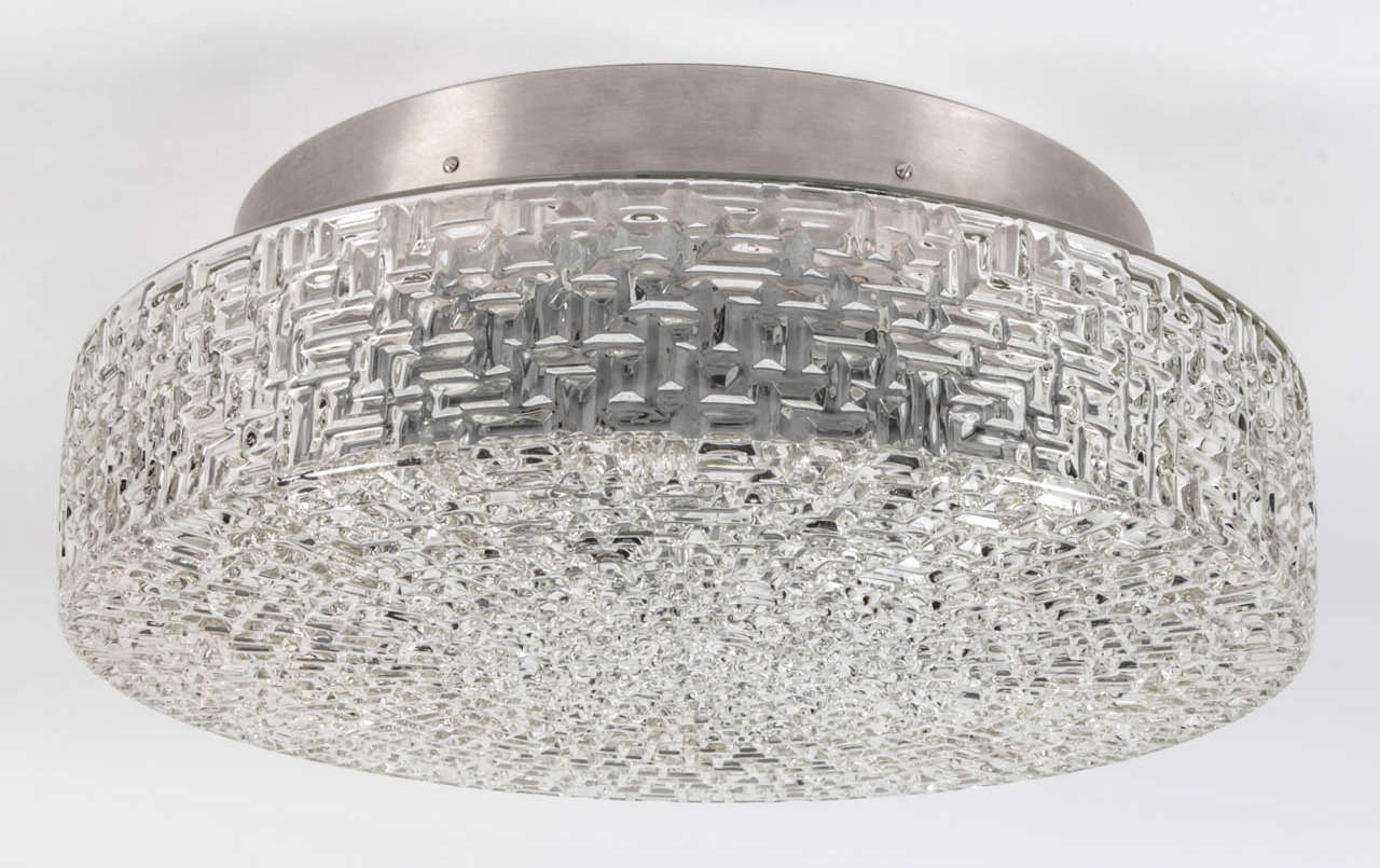A vintage textured glass and brushed aluminum flush mount signed by the German maker WILA. Due to the antique nature of this fixture, there may be some nicks or imperfections in the glass.

DIMENSIONS
Overall: 6-5/8