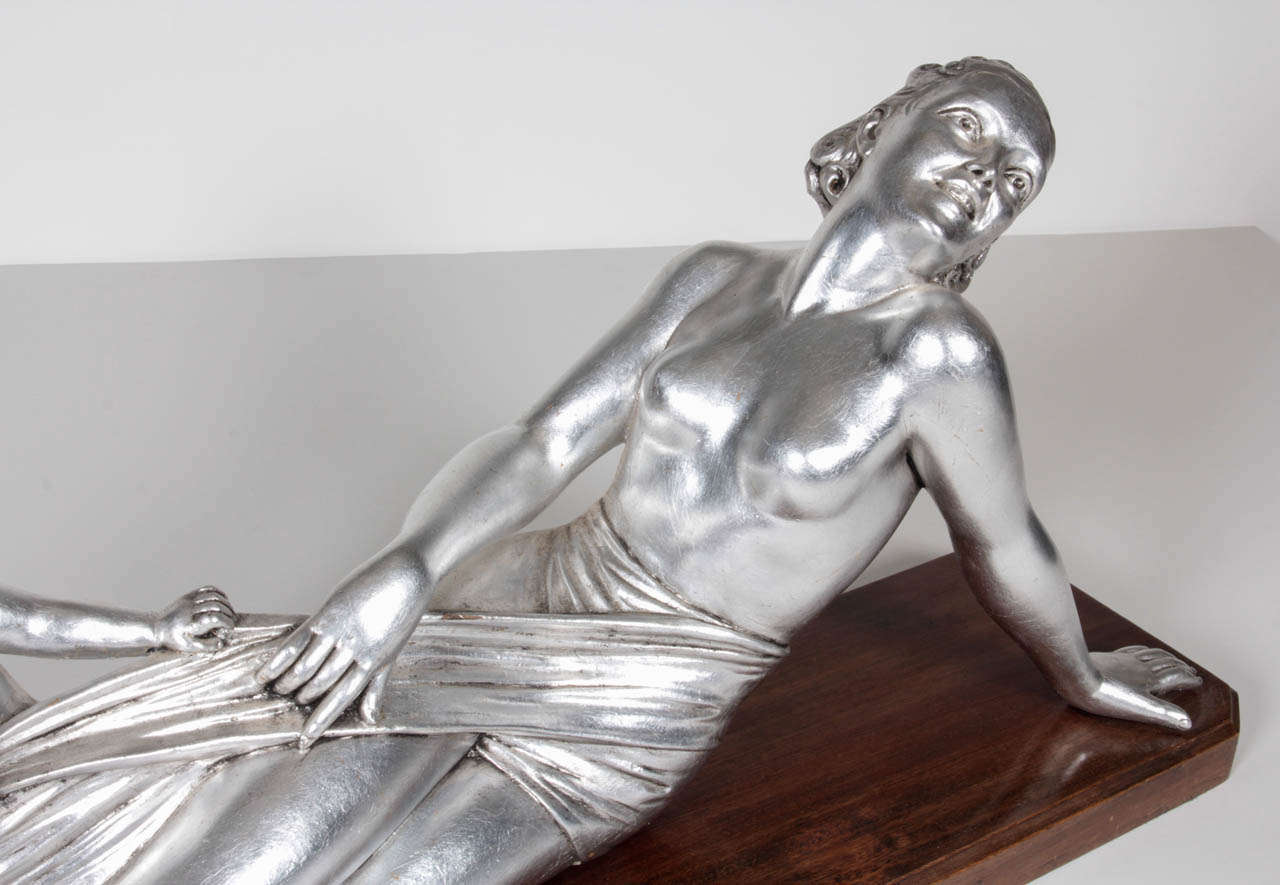 A French Art Deco sculpture of a semi-nude woman reclining with playful child at her side, on original wood base. Attributed to A. Godard
signed in pencil under base
The wood base has a few very light scratches and superficial dents barely visible.
