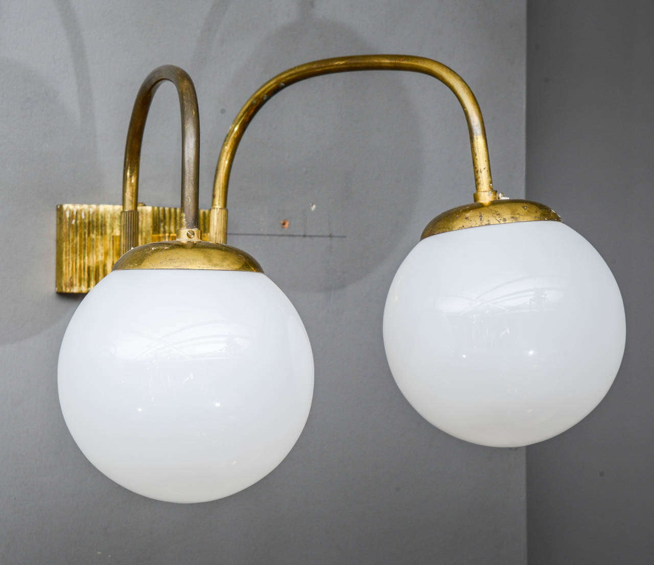 Set of six wall sconces made of brass with two glass globes.
This kind of wall sconces used to be seen in old brasseries or bistros of Paris.

New electrification.