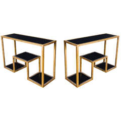 Pair of table consoles with black mirror and gilded metal.