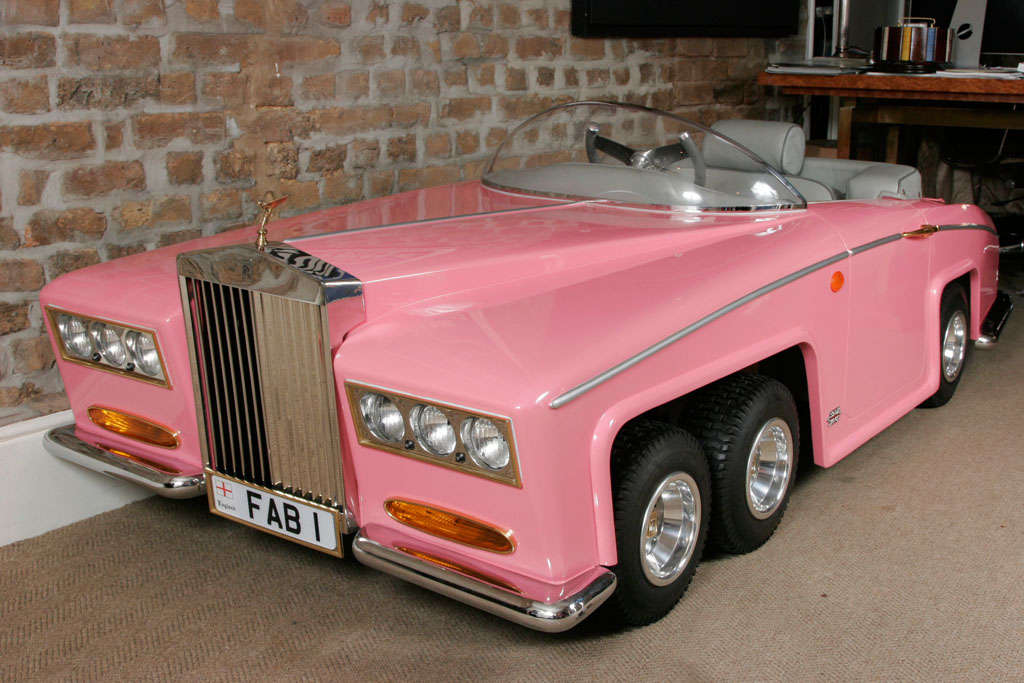 Beautifully designed unique 1/2 scale/child-size model of Lady Penelope's six wheeled rolls royce in signatory shade of candy pink. Finely detailed and of the utmost quality, features include electrically adjustable seat, functioning wipers, spirit