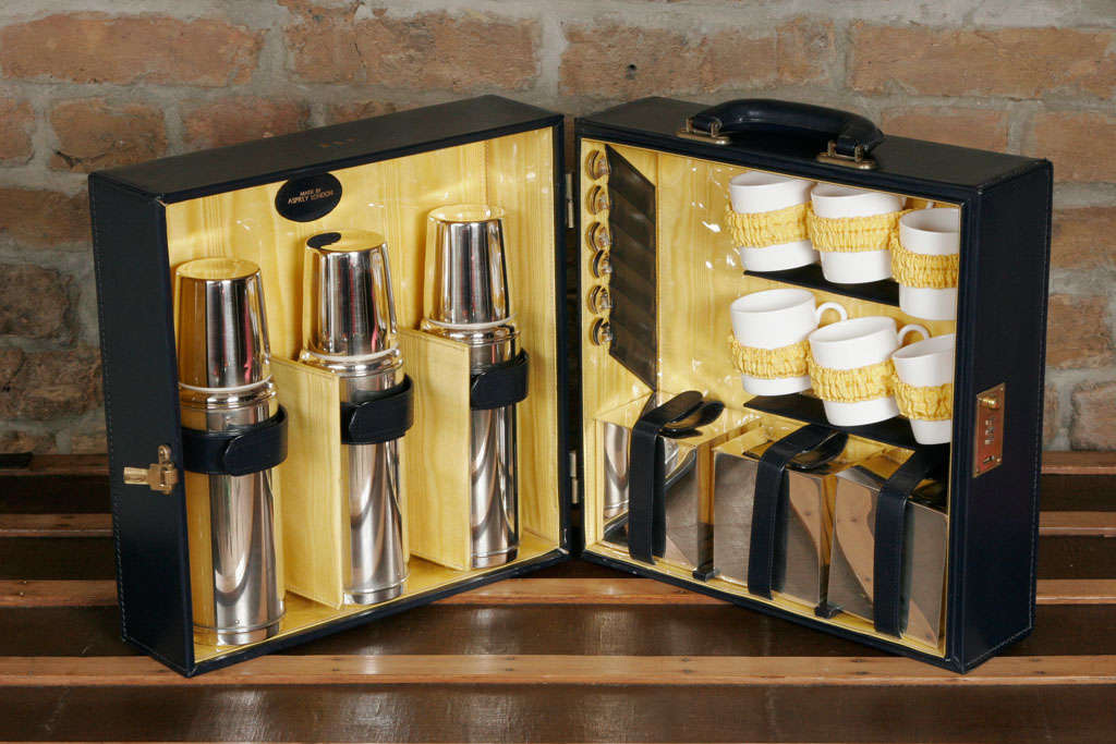 Complete picnic tea set for 6 people made by Asprey of London. Includes 3 silver plated flasks, sterling silver spoons and sandwich boxes and porcelain mugs presented in bespoke case with brass lock and studs.