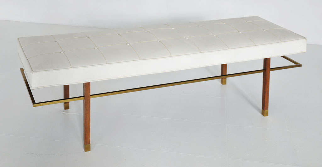Bench designed by Harvey Probber.  Mahogany legs with brass cap feet and brass stretchers.  Original white vinyl cushion.
