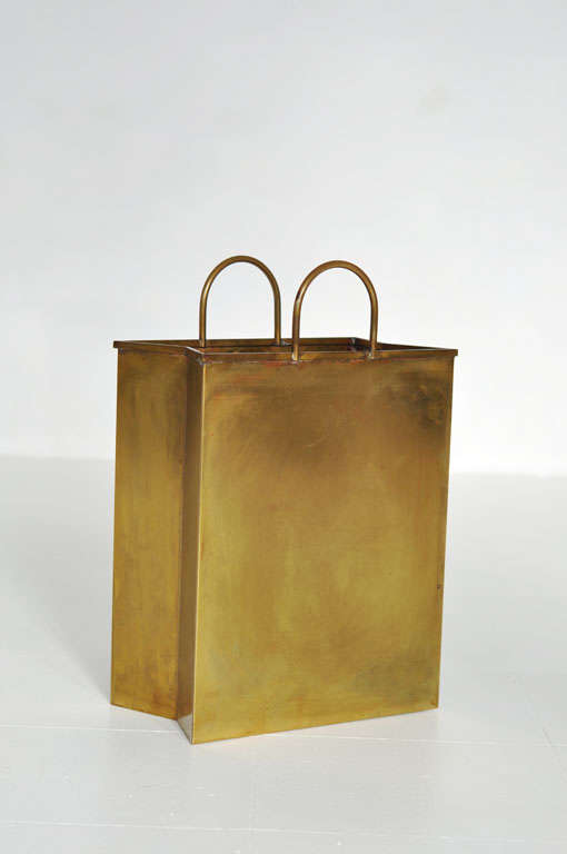 Solid brass magazine holder/wastebasket in the form of shopping bag.