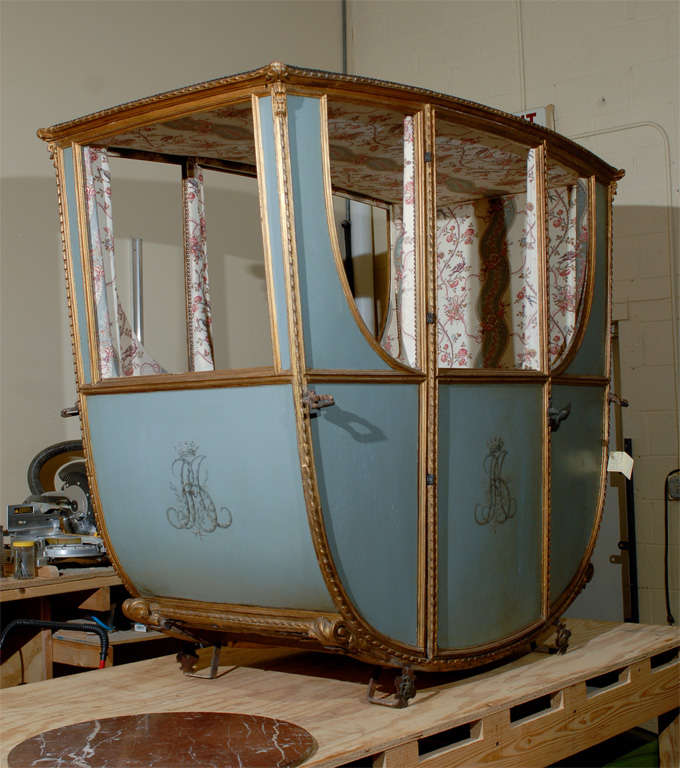 This is a wonderful piece.  It is a French carriage made for the Duchess D'Orleans with her monogram on the sides.  The carriage is painted in a lovely shade of blue with gold details.  The doors on the long sides open.  The inside has been