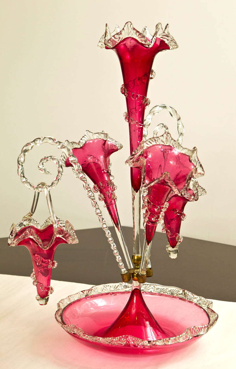 Cranberry glass epergne with three trumpets and 2 hanging baskets