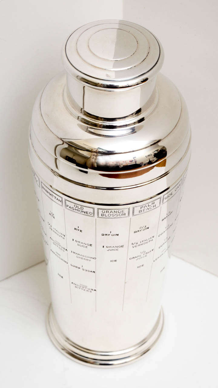 Art Deco silver-plated recipe cocktail shaker by William Suckling. The curvilinear exterior is engraved with various recipes for popular cocktails of the era such as a Palm Beach, Gin Rickey, Old Fashioned, Dry Martini, and Bronx to name a few.