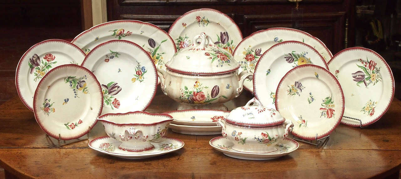 19th century hand-painted set of 73 pieces of Pexonne Faience dinner service including: 19 soup bowls, 28 dinner plates, 15 salad plates, two oval platters, one round platter, one sauce bowl, two raviers, one round bowl, a gravy dish and tureen -
