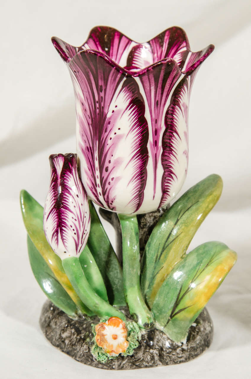 Provenance: The collection of Katherine Mellon.
An exceptional pair of large, purple and white, porcelain tulips each with a smaller tulip bud and bright green leaves on a mottled grey base. 
These are unusually large and beautiful examples of the