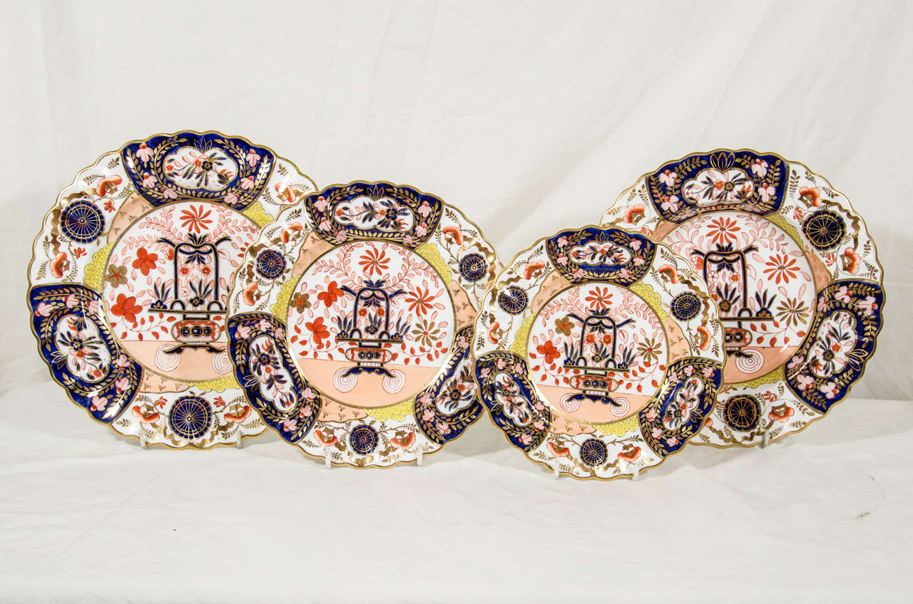 A decorative and beautifully painted set of Copeland dishes with a broad border around a central floral decoration and shaped rims trimmed in gold.
The deep cobalt blue and the iron red are traditional Imari colors. The unexpected use of yellow in
