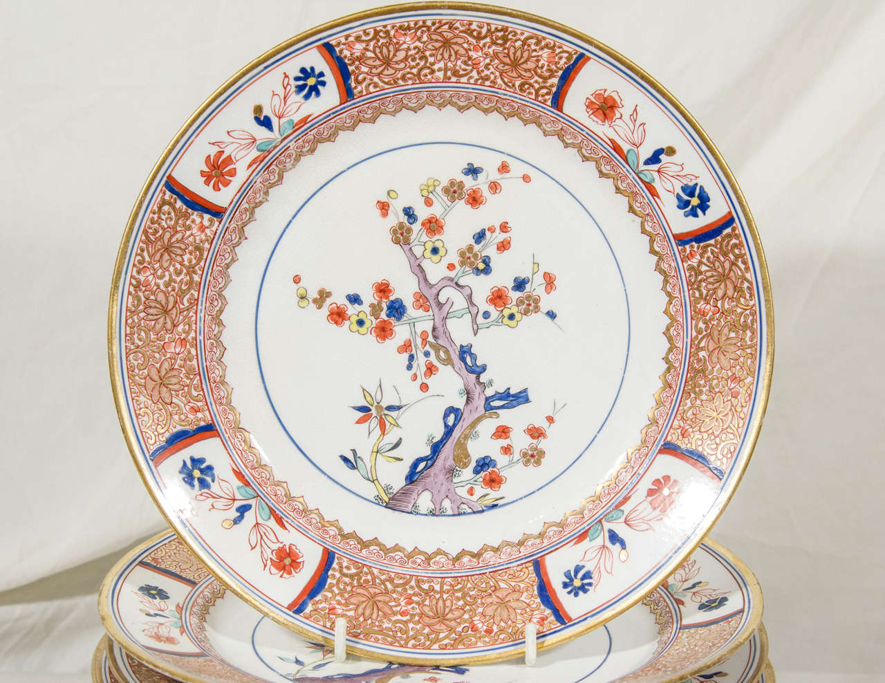 Painted with a traditional Kakiemon theme of a springtime flowering plum tree. In the Kakiemon style of bright colors painted with enamels on a pure white porcelain body with large amounts of negative (empty) space which showcases the beauty of the