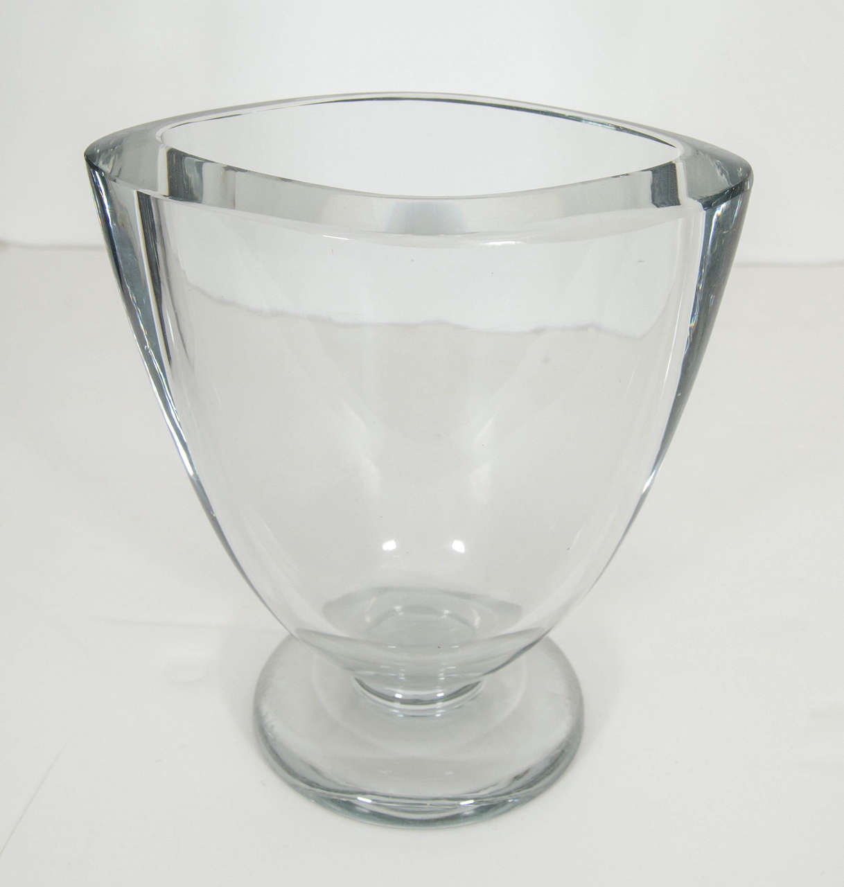 Simple and elegant, this heavy elliptical shaped, footed vase sparkles on its own, with or without the bouquet!