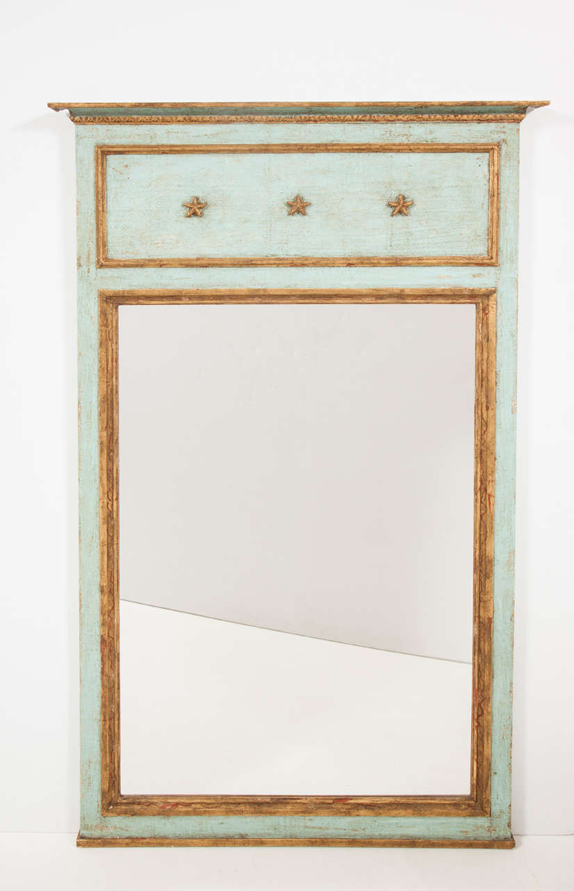 A meeting of old and new, this painted and parcel-gilt mirror is of our design and made from reclaimed wood in France. The rectangular mirror plate is surrounded by a decorative molding and surmounted by a star design, a fresh version of a centuries