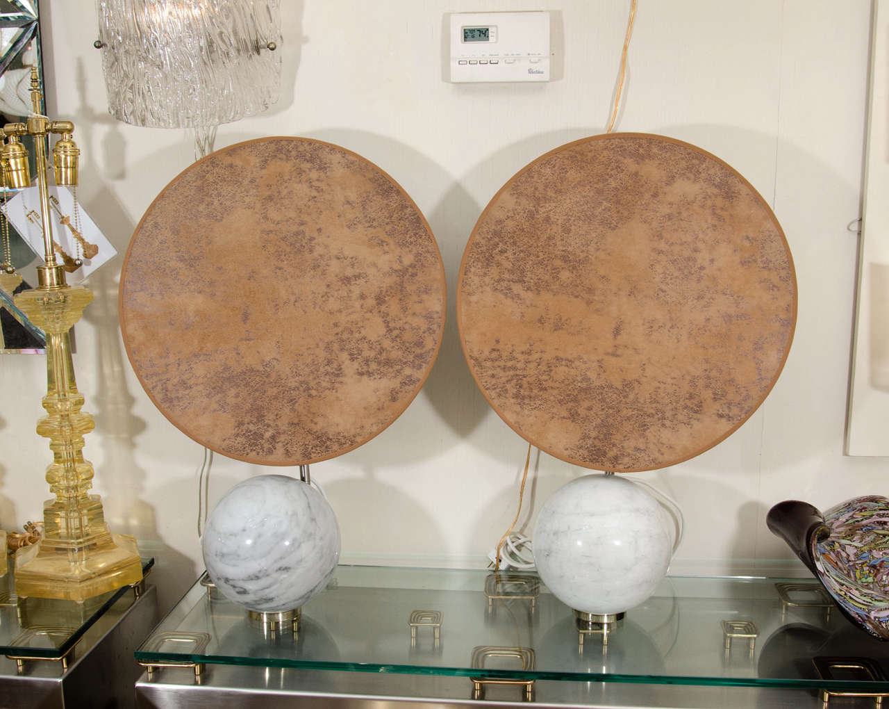 Pair of gray marble spherical table lamps with circular leather shades.