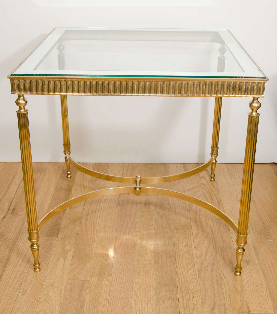 Pair of square brass decorative side tables with clear glass, mirror-trimmed top.