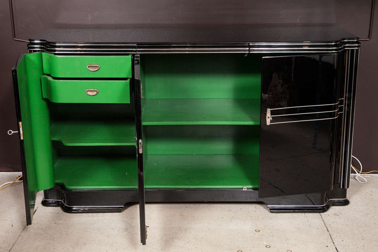 One of a kind Art Deco sideboard from Wimbledon, London, that was completely restored in 2014 with a black high gloss lacquer finish and a Jaguar racing green color interior. This piece was put through an extensive restoration process and painted in