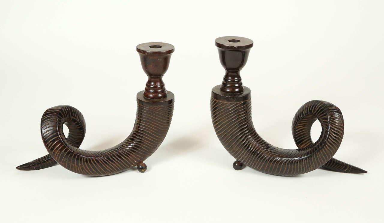 Vintage metal horn-shaped candle holders with an antiqued bronze finish.