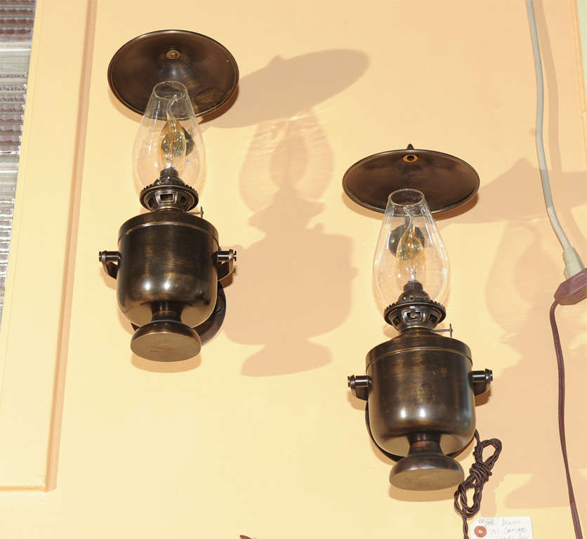 Electrified sconces circa 1900s.  Antique heavy brass gimbal ships lamps.  Top shields diameter 6 1/4