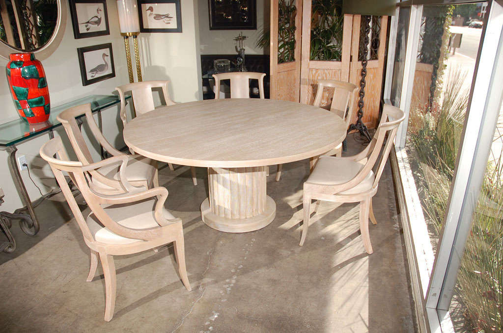 Bleached mahogany dining table and six chairs, chairs upholstered in lambskin. Table is 60