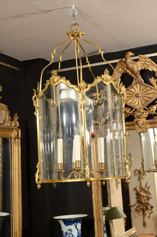 A fine Rococo gilt bronze four light hall lantern with serpentine glass and sides.