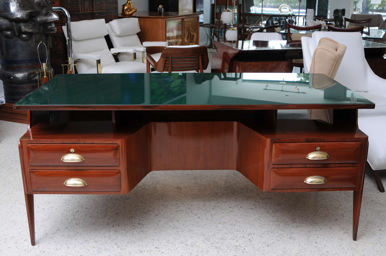 The green glass top inset over two cantilevered cabinet drawers on tapering legs. This unusual desk was a special commission by Buffa for a physician in Milan and bears the seal on the front. The drawer hardware possible replaced, Paolo Buffa.
