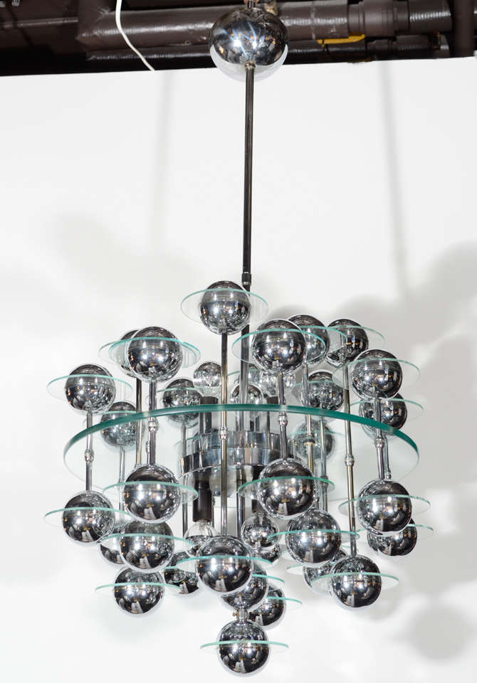 Outstanding Mid-Century Modern spherical chandelier with Space Age design. Glass center disc with suspended spheres of chrome globes, which hang at varying heights both upward and downward. Each orb has a smaller glass disc surrounding it. The