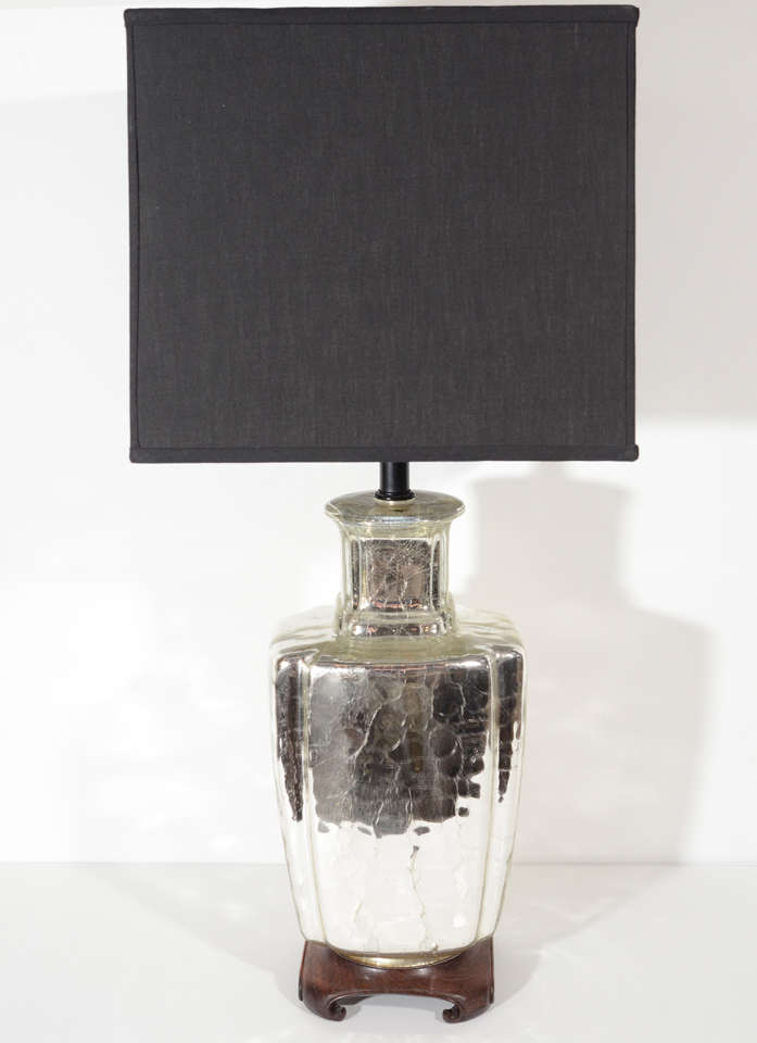 Beautiful mercury glass lamp with ginger jar or modern urn form. The lamp features a stylized hand carved pagoda base in walnut wood and a black enameled stem. Shown with custom cube shade in black linen.