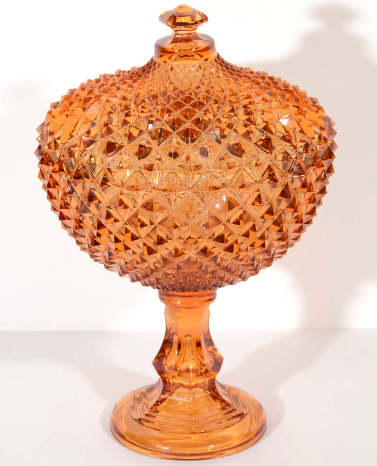 Exceptional blown glass compote or footed bowl with lid.  In a gorgeous deep amber tone and with stepped base and stylized spike 