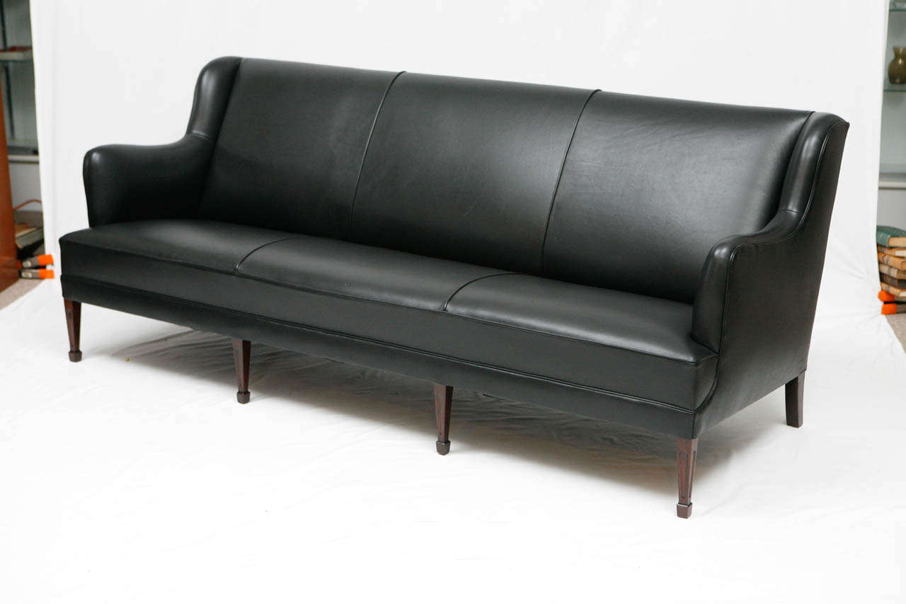 Black leather sofa designed by Frits Henningsen.   Store formerly known as ARTFUL DODGER INC