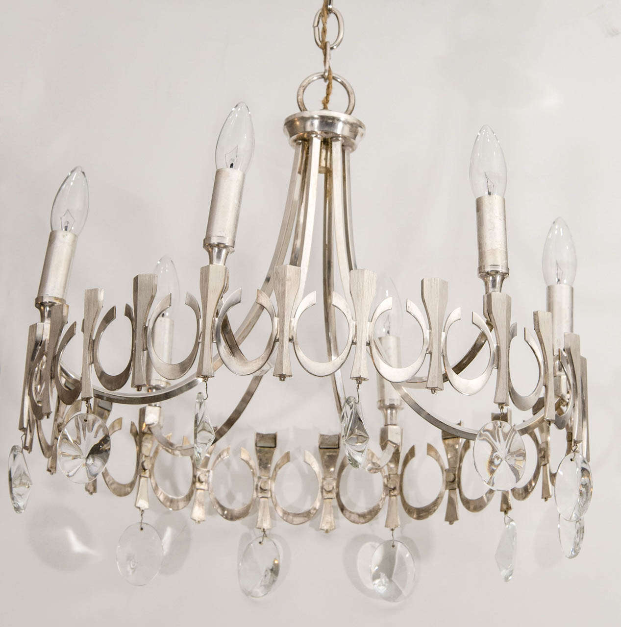 A light and airy six-arm chandelier, possibly Scoliari, with hanging crystals.