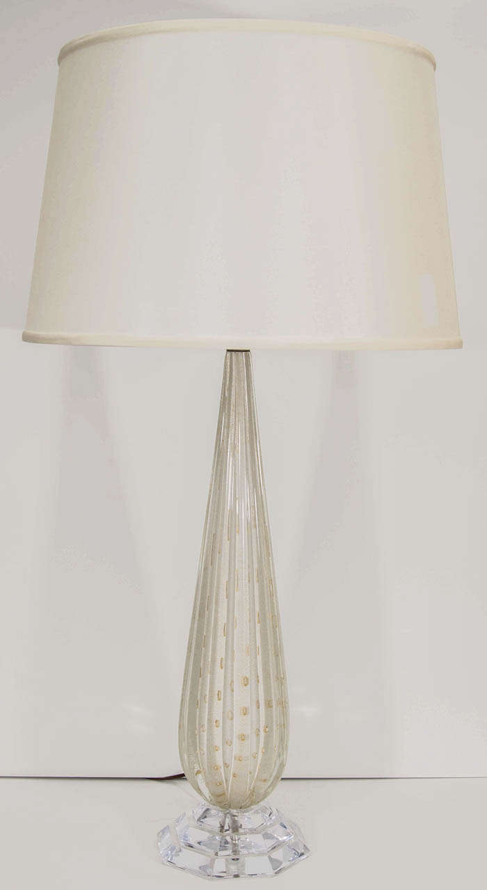 A glamorous fluted lamp in Murano glass with gold leaf inclusions on a Lucite base.