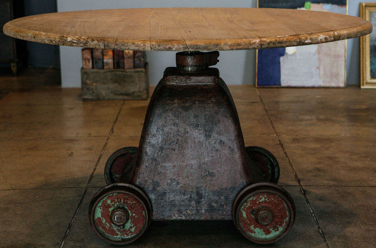 A beautifully aged industrial base round top table, perfect for an entry table or kitchen table. the pieces of this table didn't start out together but have a beautiful symmetry and similar age.