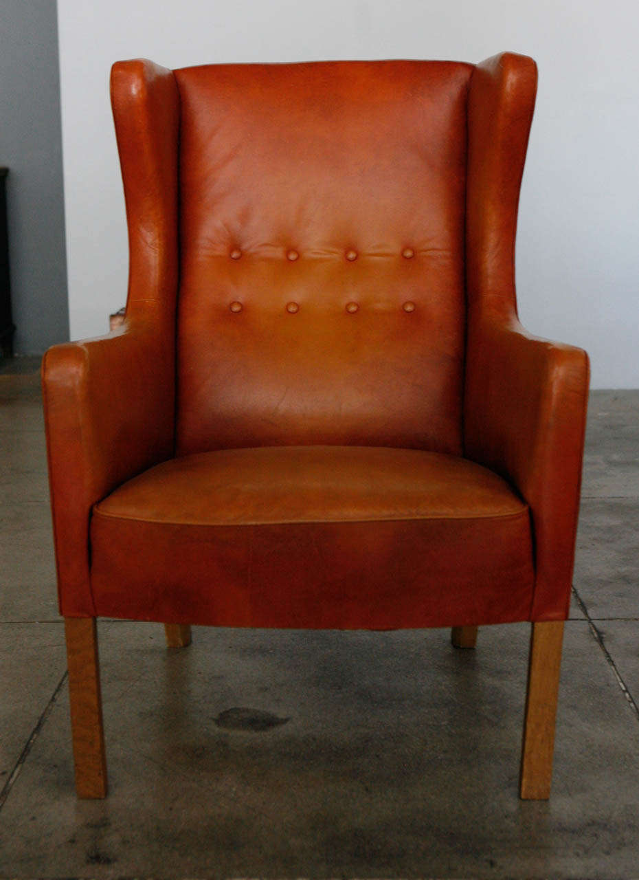 a lesser produced and often custom wingback chair by danish designer , borge mogensen. in it's original cognac leather & danish oak frame.
*no rips or repairs. minor patina to frame.