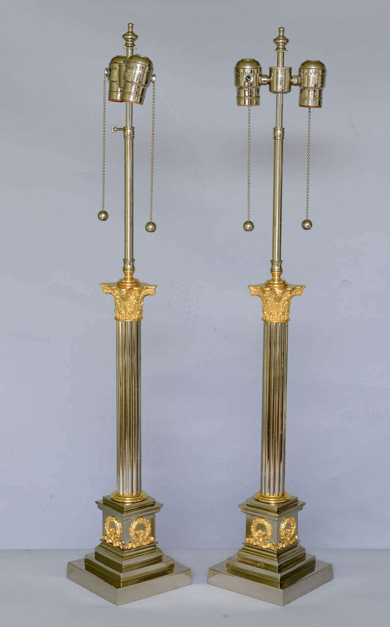 Pair of lamps, each a reeded column headed by a nicely chased Corinthian capital, on graduated plinth base decorated by wreaths.

Stock ID: D1428