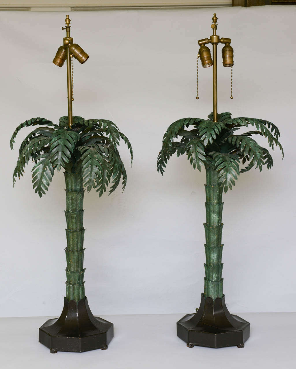 Pair of palm tree lamps, of iron, each having a mottled green finish, on black octagonal footed base. By Warren Kessler.