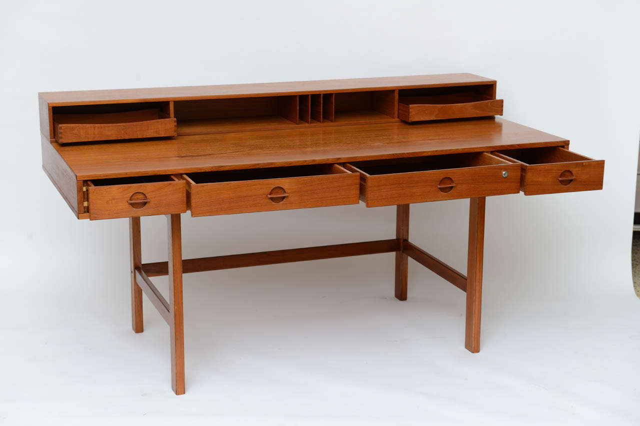 Teak desk designed by Jens Quistgaard for Lovig, circa 1960. Back gallery with removable letter trays can flip down to create a larger partners desk with storage on both sides… Genius!