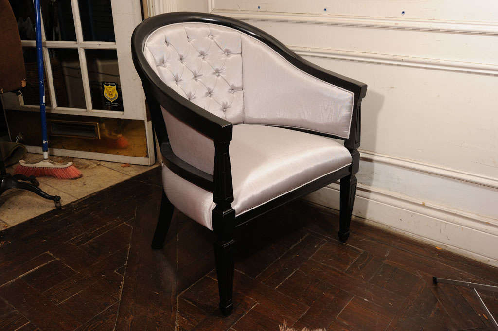 Pair of painted black chairs. Upholstered in grey color silk fabric. The central part of the back is tufted.