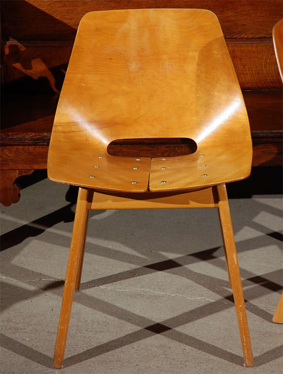 Pair of plywood chairs with riveted seats.