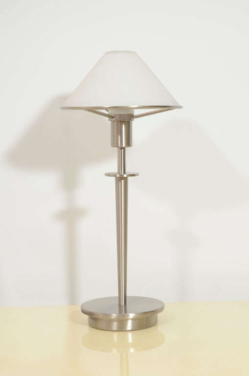 Pair of mini table lamps by Holtkotter Leuchten, Model #6.  Sweden, circa 2000.

Satin nickel base with satin white glass shade.  Lamp is equipped with a 60 W Xenon bulb and a low/high/off switch on the cord. 

Lamp is 12-5/8 inches in height;