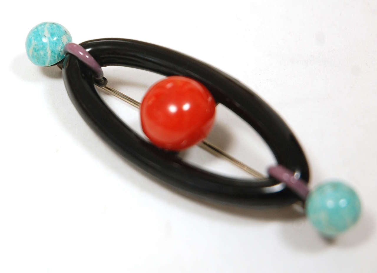 Just a perfect example of deco design in black enamel with coral 
and turquiose stones.