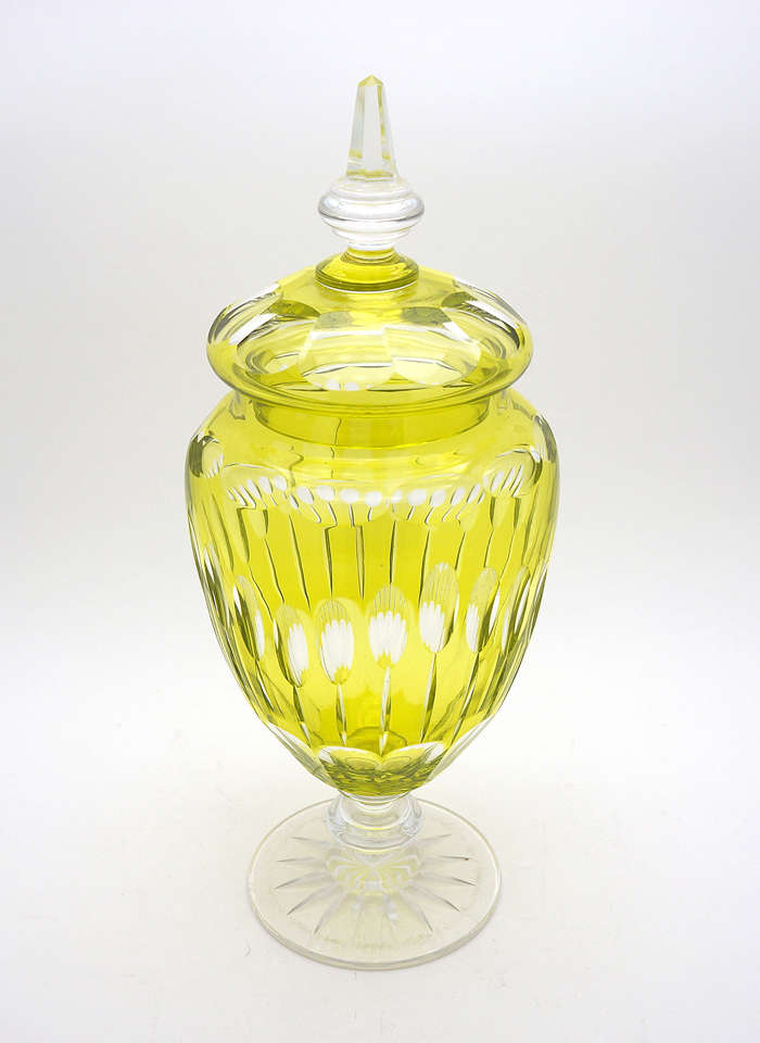 This vibrantly colored hand blown crystal vase is made by Val St. Lambert ca. 1910. The charteuse overlay is cut to clear in an interesting Art Deco pattern. A nice wide base keeps it stable and the tall matching lid gives it a decorative flair.