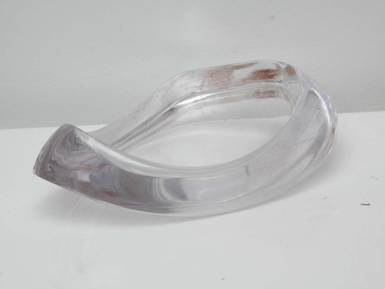 Thick amorphous lucite dish.
Measures 9 ' long by 5