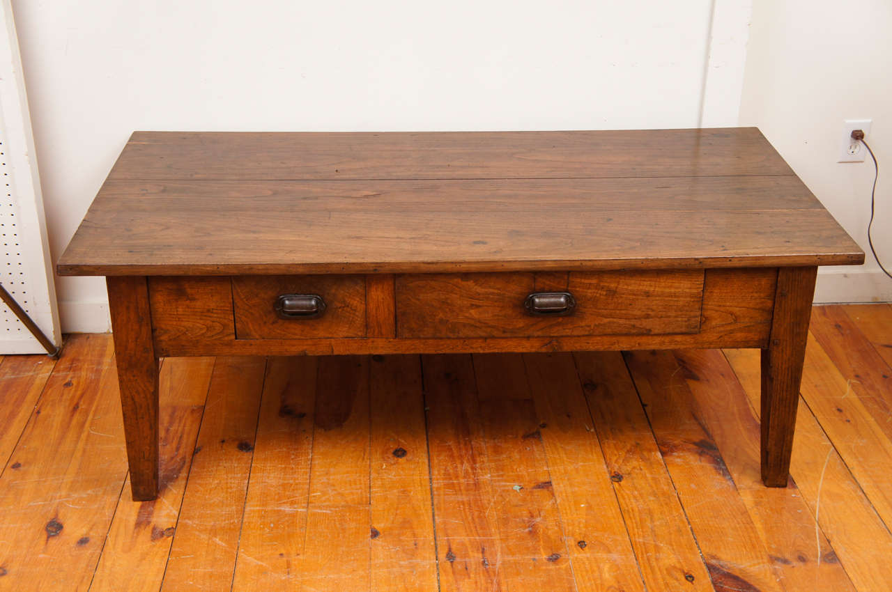 Gorgeous!! The best word to describe this very early French chestnut coffee table. The dark rich color and grain are outstanding. Simple straight forward lines, two drawers of different sizes( one divided inside), tapered legs and old metal pulls