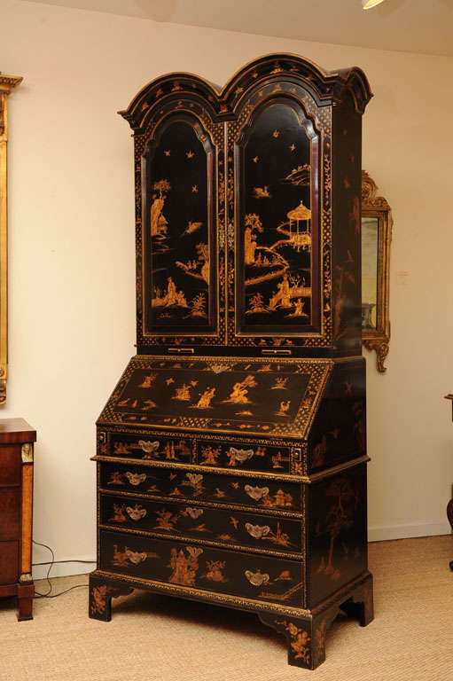 A George I style parcel gilt lacquered secretary bookcase; overall Chinoiserie decorated w/figures in Exotic Gardens
