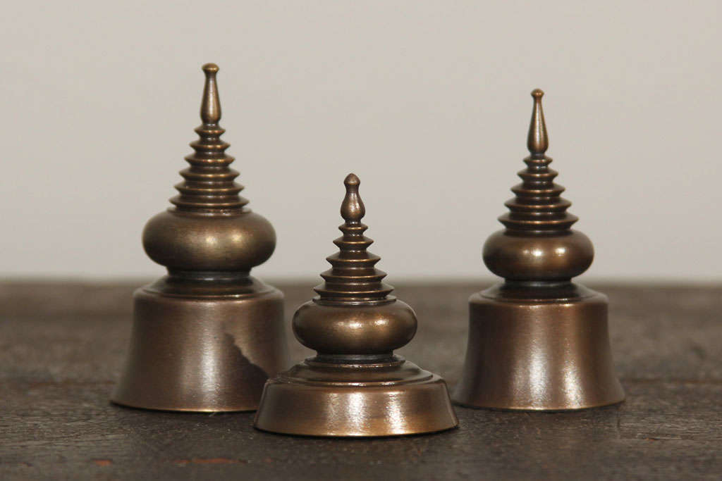 Group of three contemporary bronze ornaments cast after antique Burmese ivory seals; the seals in the form of traditional Thai chedi (stupa), or religious forms, symbolic of the burial place of Buddha. Seals were most often utilized by government
