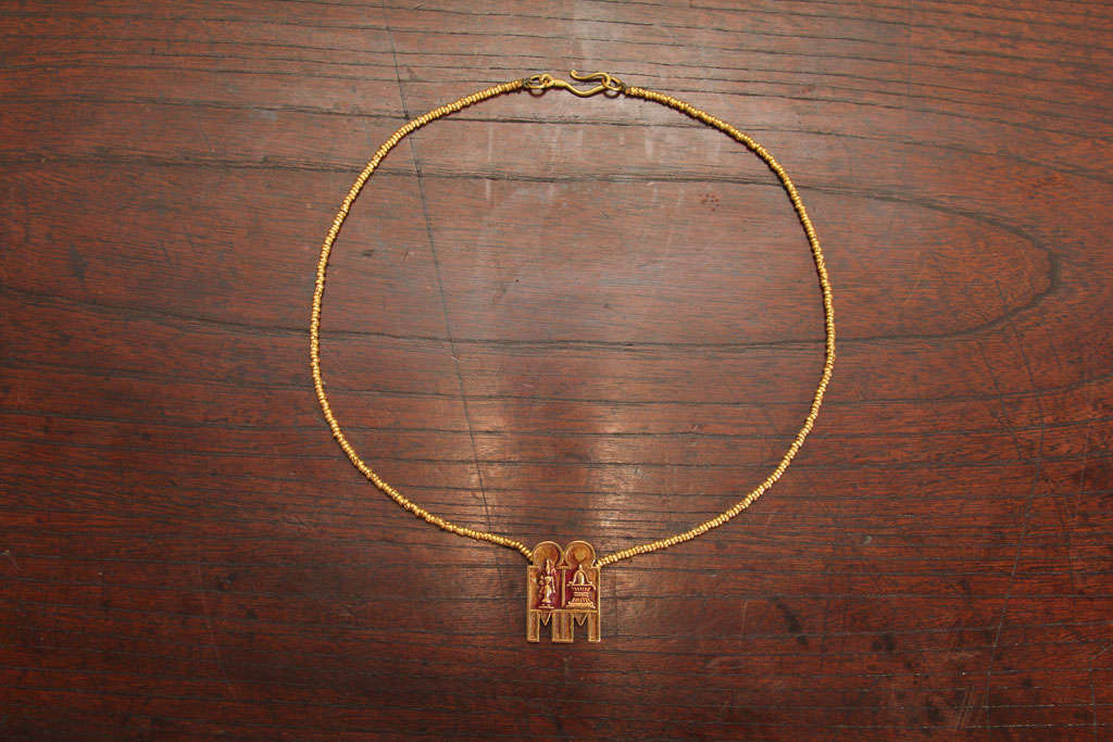 South Indian gold mangalsutra, or marriage necklace, strung with hand rolled gold beads and thali amulet. The double thali amulet, or irattaiyana thali, depicting Lakshmi, the goddess of wealth and Shiva Lingam, a symbol of fertility and the life