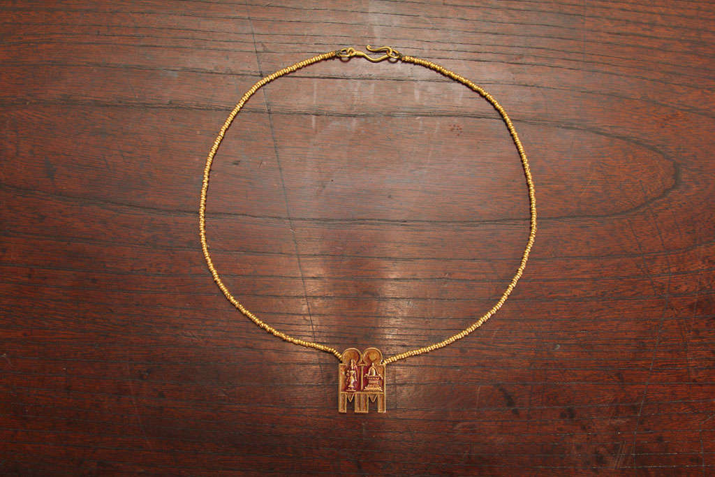 South Indian gold mangalsutra, or marriage necklace, strung with hand rolled gold beads and thali amulet. The double thali amulet, or irattaiyana thali, depicting Lakshmi, the goddess of wealth and Shiva Lingam, a symbol of fertility and the life