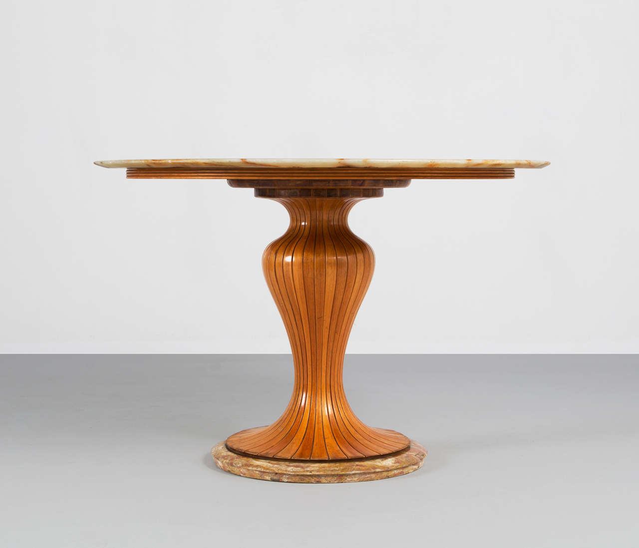 Center table, in mahogany and marble, by Osvaldo Borsani for Arredamento Borsani, Italy, 1940s. 

Borsani is well known for his modernist designs at Tecno Milano. Before he began Tecno with his twin brother, Borsani designed furniture at his